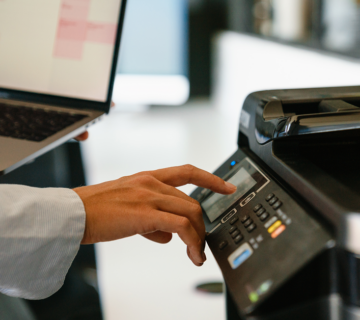 Procurement professional using office equipment representing public sector purchasing and cooperative contract usage