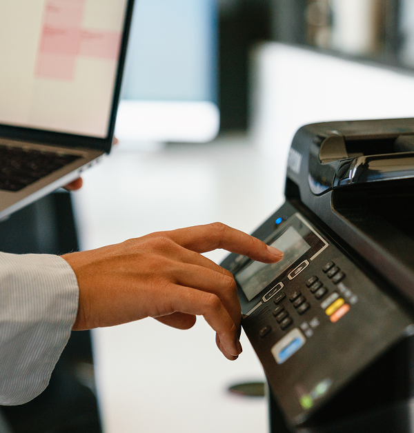 Procurement professional using office equipment representing public sector purchasing and cooperative contract usage