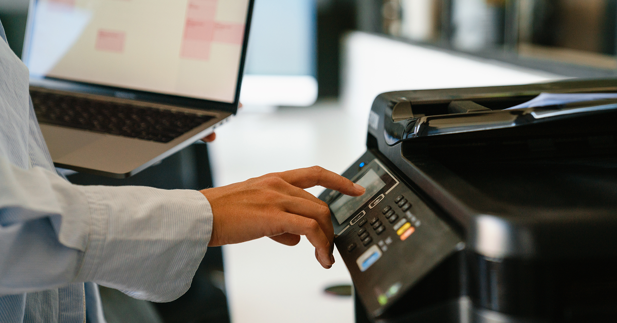 Procurement professional using office equipment representing public sector purchasing and cooperative contract usage